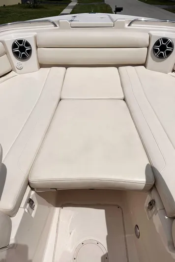 Sweet Life Yacht Photos Pics 2019 Grady-White Freedom 325 boat interior with white cushioned seating and built-in speakers.