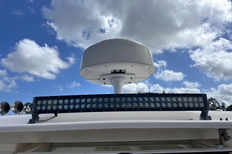 Sweet Life Yacht Photos Pics 2019 Grady-White Freedom 325 boat radar and light bar against a cloudy sky.
