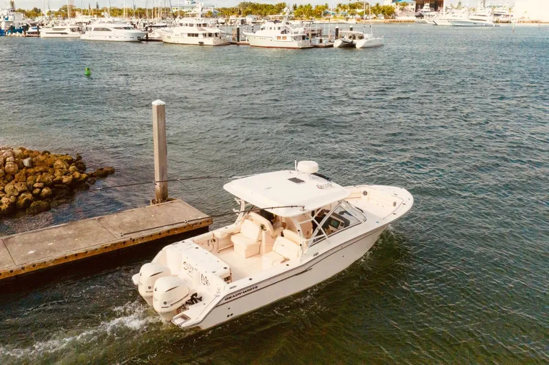 Sweet Life Yacht Photos Pics 2019 Grady-White Freedom 325 boat docked in a marina with other vessels.