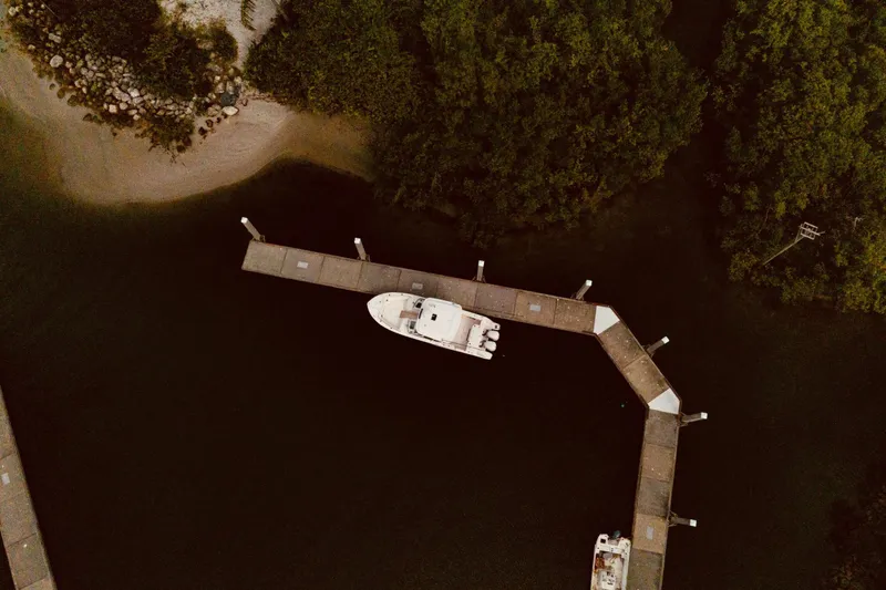 Sweet Life Yacht Photos Pics Aerial view of 2019 Grady-White Freedom 325 docked near lush greenery.