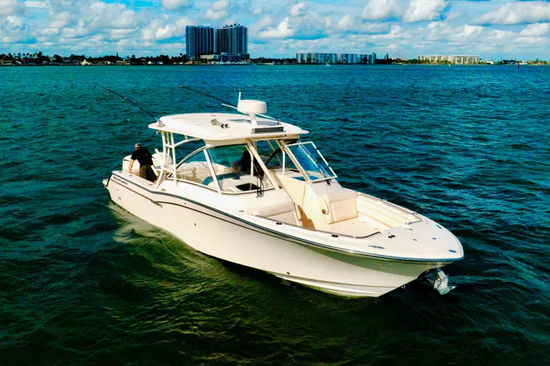 Sweet Life Yacht Photos Pics 2019 Grady-White Freedom 325 boat cruising on open water under a partly cloudy sky.