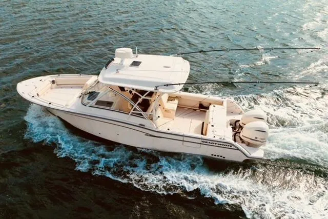 Sweet Life Yacht Photos Pics 2019 Grady-White Freedom 325 boat cruising on open water, showcasing sleek design and powerful engines.