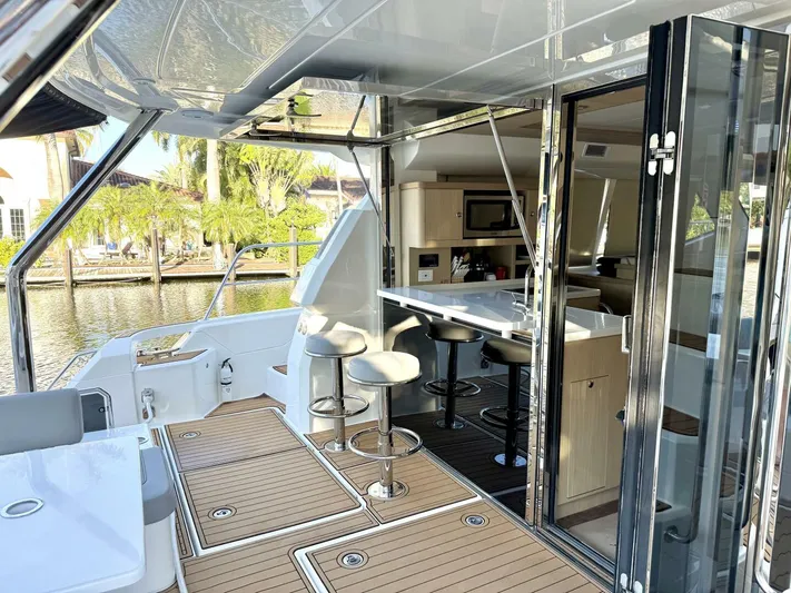 Roosterfish Yacht Photos Pics Aquila 44 yacht interior, 2022 model, featuring modern kitchen and seating area by the water.