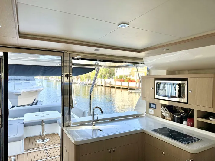Roosterfish Yacht Photos Pics Modern kitchen interior of 2022 Aquila 44 yacht with waterfront view.