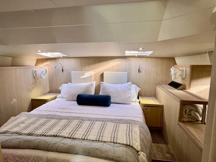 Roosterfish Yacht Photos Pics Luxurious bedroom interior of 2022 Aquila 44 yacht with cozy bedding and modern design.
