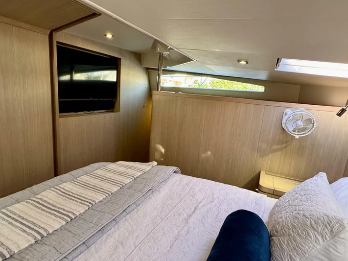 Roosterfish Yacht Photos Pics Luxurious cabin interior of 2022 Aquila 44 yacht with cozy bedding and modern amenities.