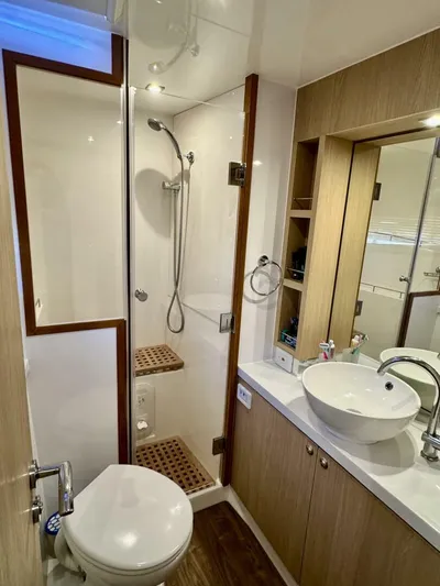 Roosterfish Yacht Photos Pics Modern bathroom in 2022 Aquila 44 yacht with shower, sink, and wooden accents.