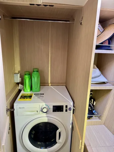 Roosterfish Yacht Photos Pics Laundry area with washing machine and detergent in Aquila 44, 2022 model.
