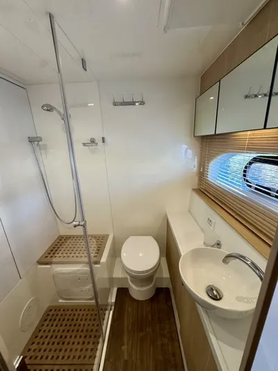 Roosterfish Yacht Photos Pics Modern bathroom in 2022 Aquila 44 yacht with shower, toilet, and sink.