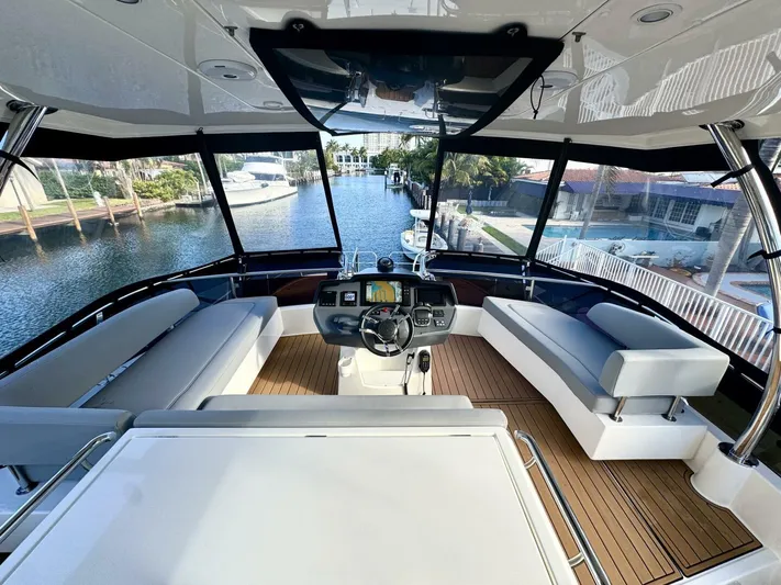 Roosterfish Yacht Photos Pics Interior view of 2022 Aquila 44 yacht with modern helm and seating area.