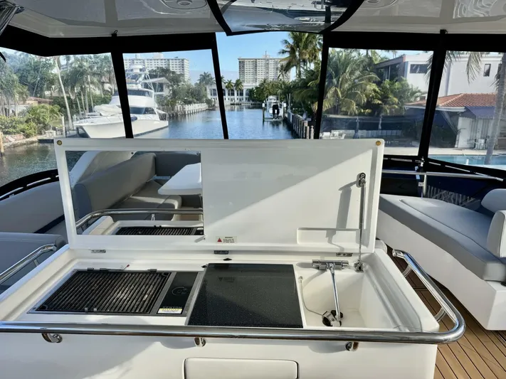 Roosterfish Yacht Photos Pics Luxury Aquila 44 yacht interior with kitchenette, overlooking marina and palm trees, 2022 model.