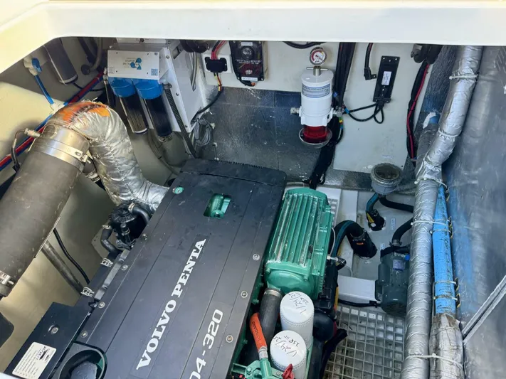 Roosterfish Yacht Photos Pics Engine room of 2022 Aquila 44 with Volvo Penta motor and various mechanical components.