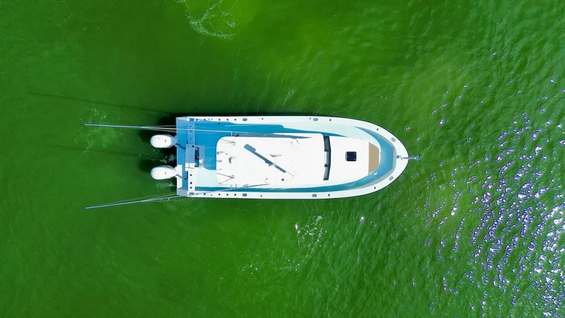 Reel Conversation Yacht Photos Pics Aerial view of 2023 Millennium Marine NuWave 37 boat on vibrant green water.
