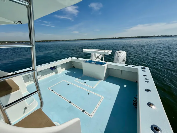 Reel Conversation Yacht Photos Pics 2023 Millennium Marine NuWave 37 boat on calm water, featuring spacious deck and modern design.