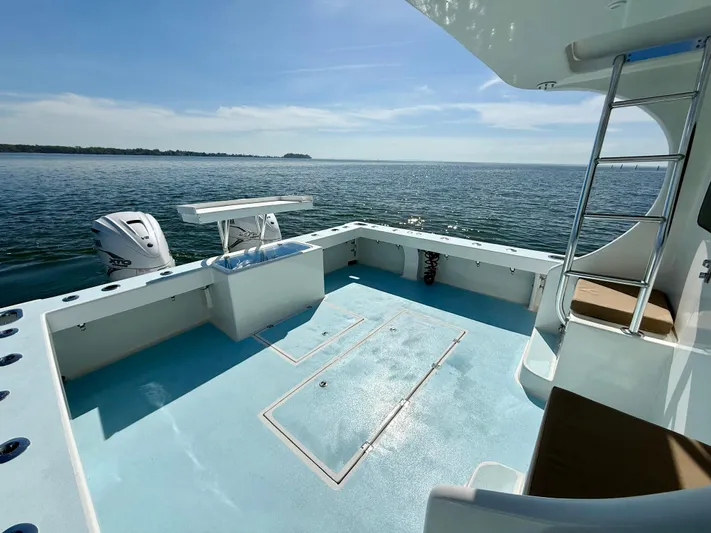 Reel Conversation Yacht Photos Pics 2023 Millennium Marine NuWave 37 boat deck with ocean view and ladder.