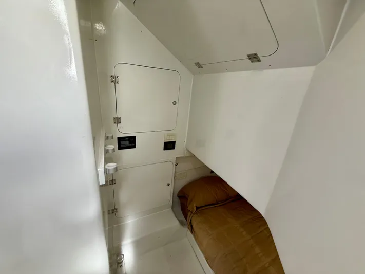 Reel Conversation Yacht Photos Pics 2023 Millennium Marine NuWave 37 cabin interior with compact bed and storage compartments.