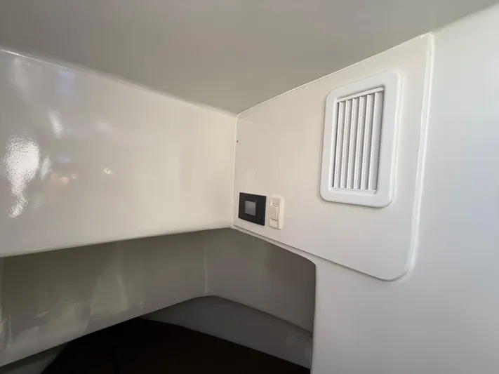Reel Conversation Yacht Photos Pics Interior cabin of 2023 Millennium Marine NuWave 37 with vent and control panel.