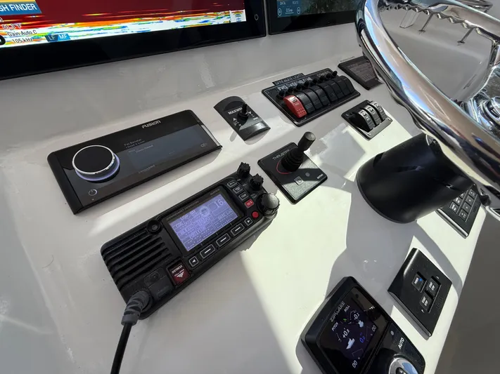 Reel Conversation Yacht Photos Pics Control panel of 2023 Millennium Marine NuWave 37 with navigation and communication equipment.
