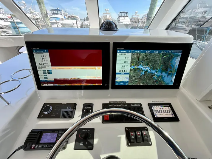 Reel Conversation Yacht Photos Pics 2023 Millennium Marine NuWave 37 dashboard with dual navigation screens and control panel.