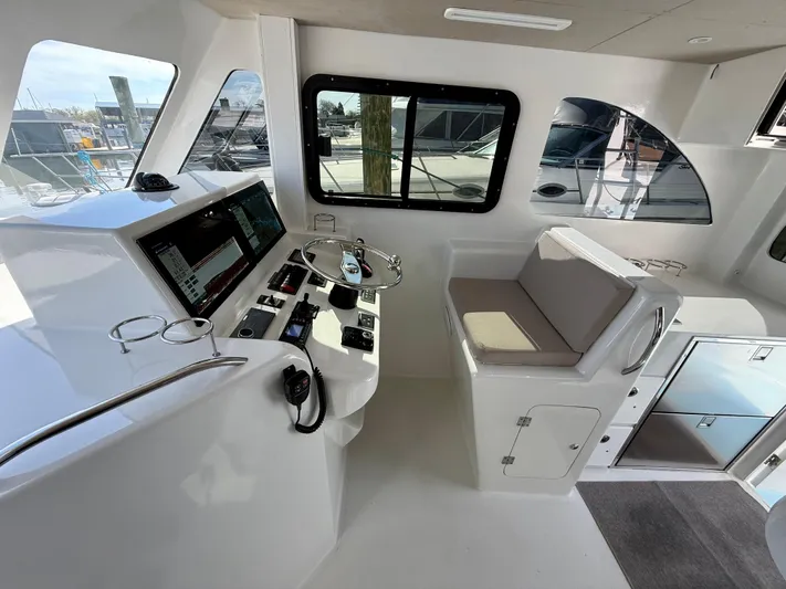 Reel Conversation Yacht Photos Pics Modern helm station of 2023 Millennium Marine NuWave 37 with advanced navigation controls.