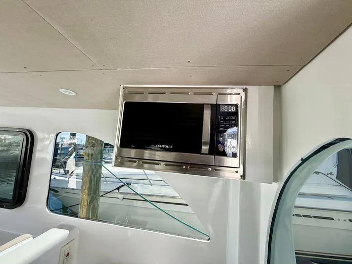 Reel Conversation Yacht Photos Pics Built-in microwave on 2023 Millennium Marine NuWave 37 boat interior.