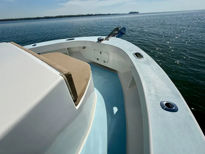 Reel Conversation Yacht Photos Pics 2023 Millennium Marine NuWave 37 boat on calm water, showcasing sleek deck design.