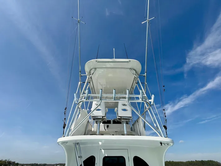 Reel Conversation Yacht Photos Pics 2023 Millennium Marine NuWave 37 boat with tower against clear blue sky.