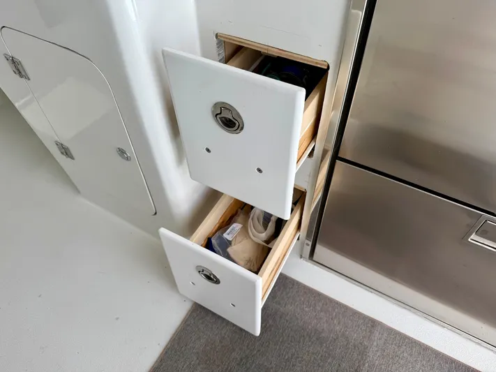 Reel Conversation Yacht Photos Pics Storage drawers on a 2023 Millennium Marine NuWave 37 boat interior.