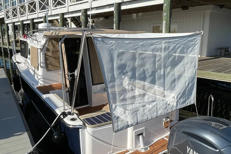  Yacht Photos Pics 2026 Ranger Tugs R-27 boat docked with canopy and Yamaha engine.