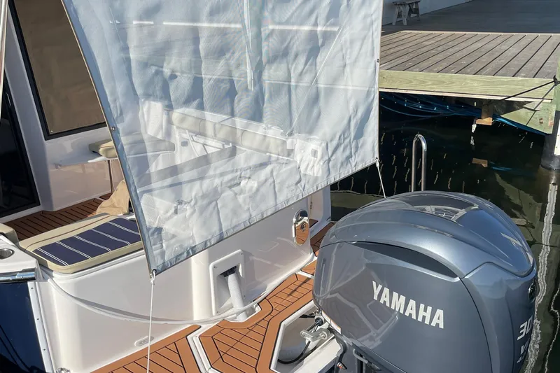  Yacht Photos Pics 2026 Ranger Tugs R-27 boat with Yamaha engine, docked with sunshade and seating area.