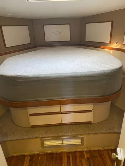  Yacht Photos Pics 1987 Bertram 50 Convertible cabin interior with bed and storage drawers.