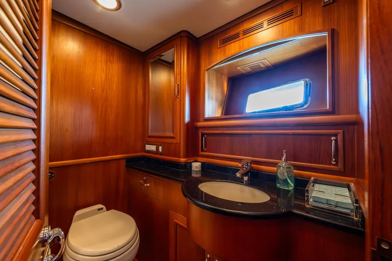 Grand Finale Yacht Photos Pics Luxurious 2007 Grand Banks 59 Aleutian yacht bathroom with wood paneling and modern fixtures.
