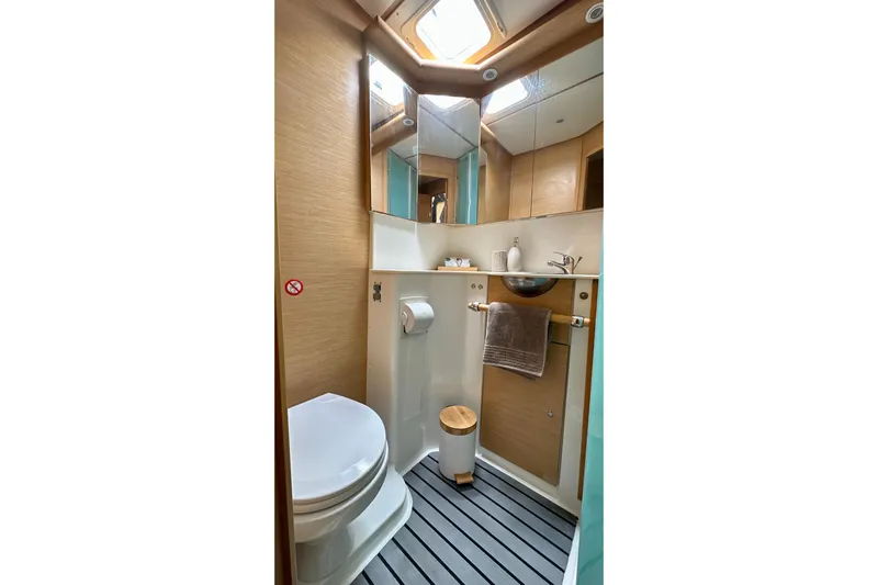  Yacht Photos Pics Compact bathroom in 2008 Lagoon 500 yacht with modern fixtures and wooden accents.