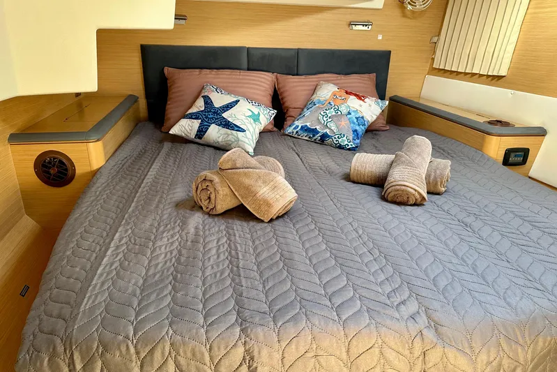  Yacht Photos Pics Luxurious cabin interior of 2008 Lagoon 500 yacht with cozy bedding and decorative pillows.