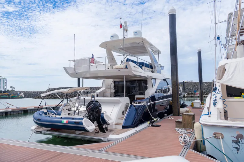  Yacht Photos Pics Azimut 66 FLY 2017 yacht docked at marina with inflatable boat on deck.
