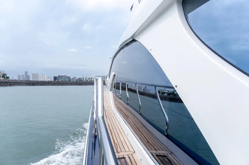  Yacht Photos Pics Side view of 2017 Azimut 66 FLY yacht cruising on calm waters.