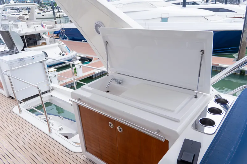  Yacht Photos Pics Outdoor kitchenette on 2017 Azimut 66 FLY yacht, featuring sink and storage.