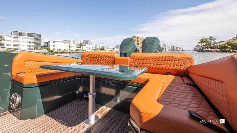 2025 Skipper 38 Twin 400 - Rolls-royce Limited Ed Yacht Photos Pics Luxurious Skipper-BSK 38NC boat interior with orange seating, modern design, and scenic waterfront view.