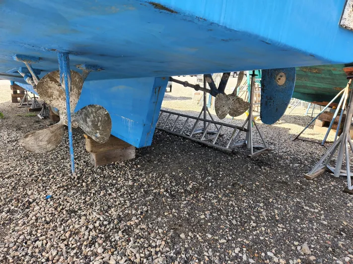  Yacht Photos Pics 1980 Tuna Rose Brothers boat hull and propellers on gravel.