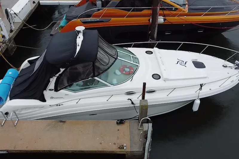  Yacht Photos Pics 2004 Sea Ray 340 Sundancer docked, featuring sleek design and black canopy.