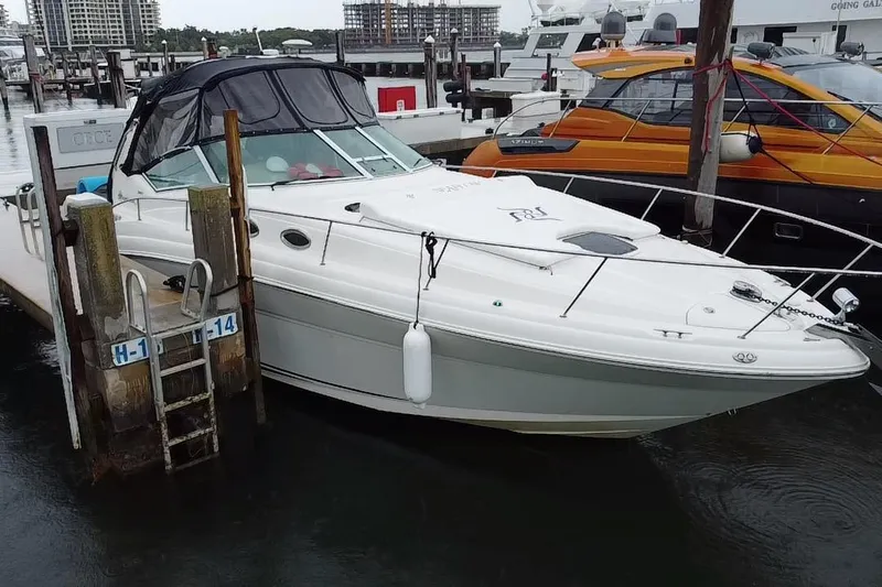  Yacht Photos Pics 2004 Sea Ray 340 Sundancer docked at marina, featuring sleek design and white exterior.