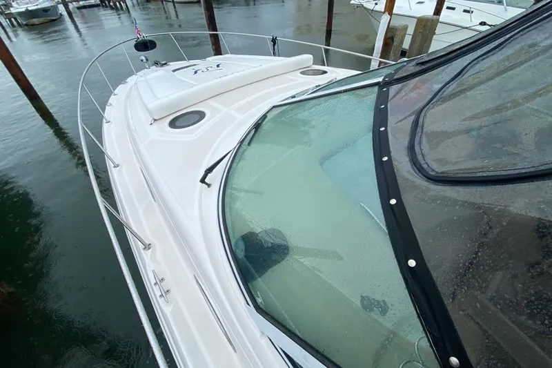  Yacht Photos Pics 2004 Sea Ray 340 Sundancer boat docked in rainy marina.