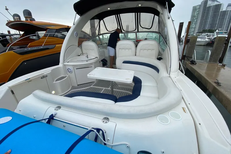  Yacht Photos Pics 2004 Sea Ray 340 Sundancer boat interior with seating and table at marina.