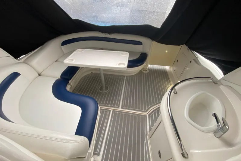  Yacht Photos Pics 2004 Sea Ray 340 Sundancer interior with seating, table, and sink in a cozy cabin.