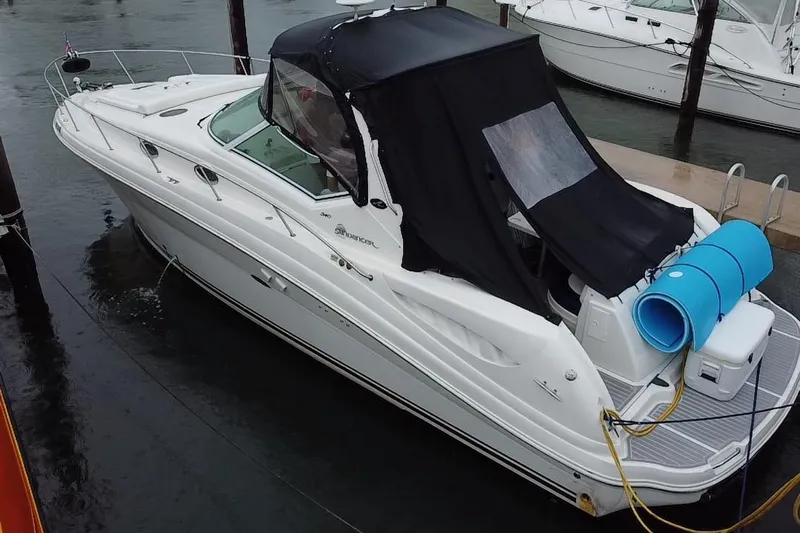  Yacht Photos Pics 2004 Sea Ray 340 Sundancer yacht docked, featuring a black canopy and white hull.