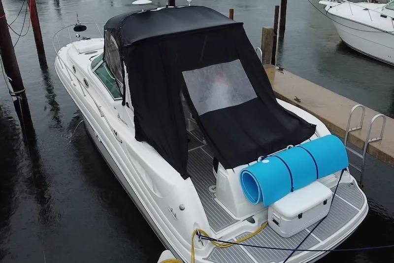  Yacht Photos Pics 2004 Sea Ray 340 Sundancer docked with black canopy and blue floatation mat.