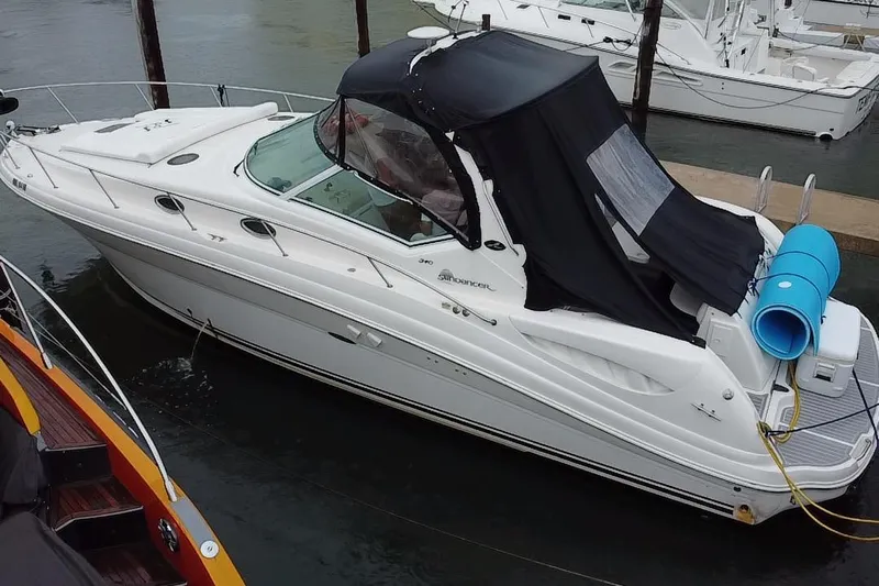  Yacht Photos Pics 2004 Sea Ray 340 Sundancer boat docked with black canopy and blue fender.