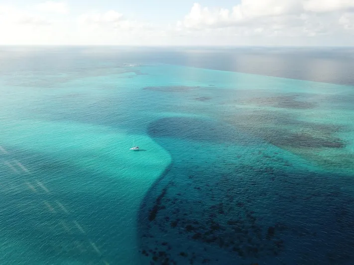Sv Tonic III Yacht Photos Pics Aerial view of Beneteau Oceanis 41.1 sailing in clear turquoise waters, 2012 model.