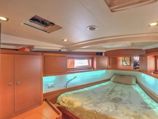 Sv Tonic III Yacht Photos Pics Luxurious cabin interior of 2012 Beneteau Oceanis 41.1 yacht with cozy bed and wooden finish.