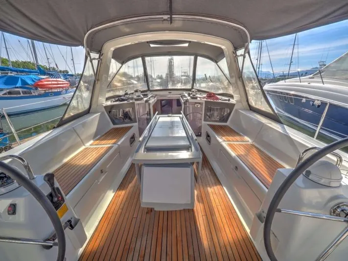 Sv Tonic III Yacht Photos Pics Beneteau Oceanis 41.1 sailboat cockpit, 2012 model, featuring spacious seating and wooden flooring.